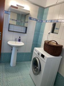 a bathroom with a washing machine and a sink at SONIA in Kallithea Halkidikis +24 photos