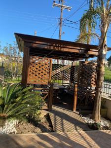 a wooden pavilion with a bench in a park at SONIA in Kallithea Halkidikis