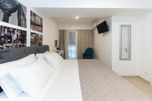 a bedroom with a large bed with white pillows at CentRooms Kovac in Zadar