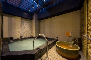 a large bath tub in a bathroom with a sink at APA Hotel Sugamo Ekimae in Tokyo