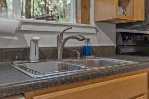a kitchen sink with a faucet next to a window at Waterfront Cottage, Fiery Sunsets in Charlotte +17 photos