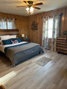 a bedroom with a bed and a ceiling fan at Waterfront Cottage, Fiery Sunsets in Charlotte