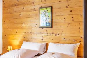 two beds in a room with wooden walls at Ferienwohnung Parterre in Wallgau