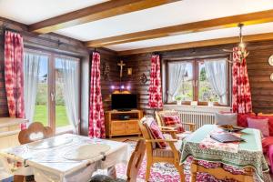 a living room with a table and chairs and a tv at Ferienwohnung Parterre in Wallgau