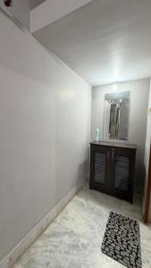 a white room with a mirror and a counter at Cozy Cove 3BHK in Cuttack