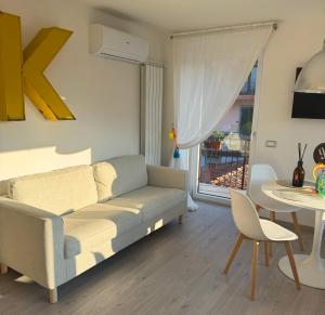a living room with a couch and a table at L4K3 Luxury Apartment - Lake View, Free Pool, Balcony, 50 m to Lake & Historic Center, 90 m2 in Pisogne