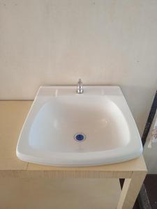 a white sink sitting on top of a table at Uros Suyawi Titicaca Lodge in Puno