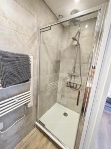 a shower with a glass door in a bathroom at Le Cocon des Remparts in Gravelines +25 photos