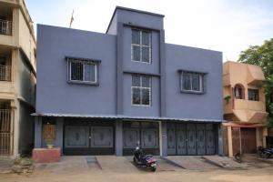 a blue building with a scooter parked in front of it at Cozy Cove 3BHK in Cuttack