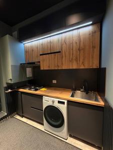 a kitchen with a sink and a washing machine at The Loft Hostel in Tashkent
