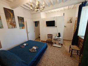 a bedroom with a blue bed and a tv at Nostra Torre in Filettole