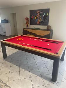 a ping pong table with a red cloth on it at Ô Sens Jacuzzi et Massages in Challans +13 photos