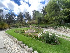 a garden with a fountain and flowers in a park at Casa Betania in La Paz