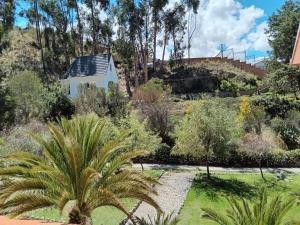 a view of a garden with a house in the background at Casa Betania in La Paz