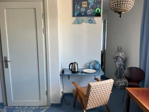 a room with a table and a chair and a desk at Lalala in Sopot