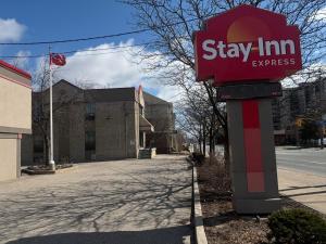 a red sign that says stay inn express on a street at Stay Inn Express Toronto in Toronto