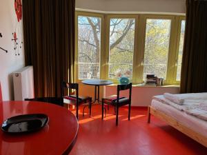 a living room with a table and chairs and a window at Lalala in Sopot