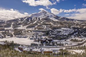 a view of a resort with a snow covered mountain at Mountain Lake Condo Unit 402D in Big Sky