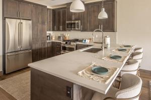 a kitchen with a large island with a counter top at Mountain Lake Condo Unit 402D in Big Sky