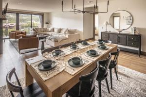 a living room with a wooden table and chairs at Mountain Lake Condo Unit 402D in Big Sky