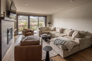 a living room with a couch and a table at Mountain Lake Condo Unit 402D in Big Sky +25 photos