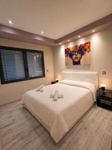 a bedroom with a large bed with two towels on it at 4 Seasons Apartment in Taverne
