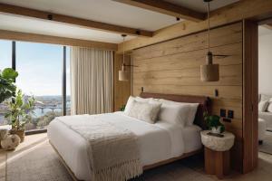 a bedroom with a white bed and a large window at 1 Hotel Austin in Austin