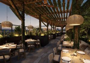 an outdoor restaurant with tables and chairs and chandeliers at 1 Hotel Austin in Austin +10 photos