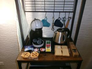 a table with a coffee maker and food on it at Capri Coral Home in Anacapri