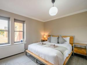 a bedroom with a large white bed and a window at 3 Bed in Alexandria oc-88758 in Balloch