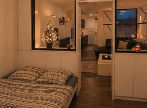 a bedroom with a bed and a window with a christmas tree at Ninche's Penthouse - free private parking in Pljevlja
