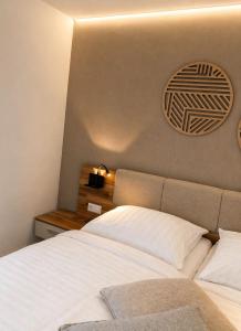 a bedroom with a bed and a clock on the wall at Sindelfingen Apartments in Sindelfingen