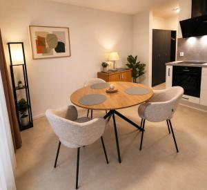 a table and four chairs in a living room at Sindelfingen Apartments in Sindelfingen