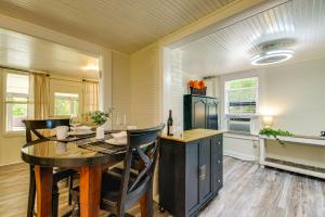 a dining room with a table and chairs and a kitchen at Lakefront Ozarks Home w/ Private Dock & Patio! in Roach +19 photos