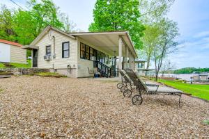 a bench sitting in front of a house at Lakefront Ozarks Home w/ Private Dock & Patio! in Roach