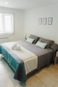 a large bed in a white room with at RGA Apartments in Río Grande