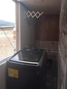 a kitchen with a stove in a room with a window at Aparta studio Zona Centro in Darién