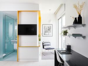a home office with a desk and a tv on a wall at Frame Hotel - Treehouse in Austin