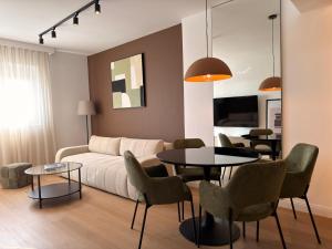 a living room with a couch and a table and chairs at Marea Apartment in Bar