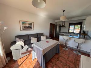 a living room with a couch and a table at Ático luminoso con terraza privada in Sanlúcar de Barrameda