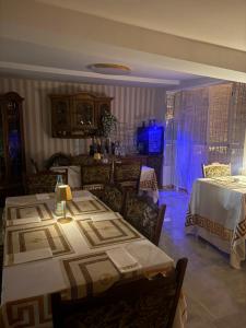 a dining room with two tables and a room with two beds at Villa EDEN BLICK in Edenkoben