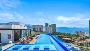 a swimming pool on top of a building with a view of the ocean at Monyxbnb at Zoho Skies in Puerto Vallarta
