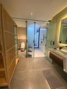 a bathroom with a shower and a sink and a toilet at منتجع تربل فور - Triple Four Resort in Buraydah +33 photos