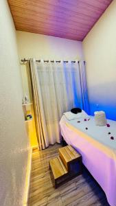 a small bedroom with a bed and a wooden floor at Montana Stay B&B in Ruhengeri