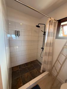 a shower with a glass door in a bathroom at Le TeRava - Beach House in Ataiti +61 photos