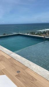 a swimming pool with a view of the ocean at 808 Vista para o Mar in Salvador