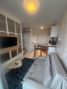a living room with a couch and a kitchen at 808 Vista para o Mar in Salvador