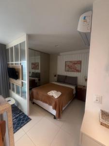 a bedroom with a bed and a television in it at 808 Vista para o Mar in Salvador +28 photos