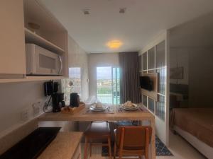 a kitchen with a table and chairs in a room at 808 Vista para o Mar in Salvador