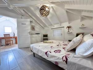 a bedroom with a large bed and a table at Villa d'Happy Bay - Panoramic View of Caribbean and sunsets in Friar's Bay +32 photos